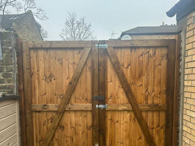 The braced back of a pair of timber driveway gates, fitted with a drop bolt and latch