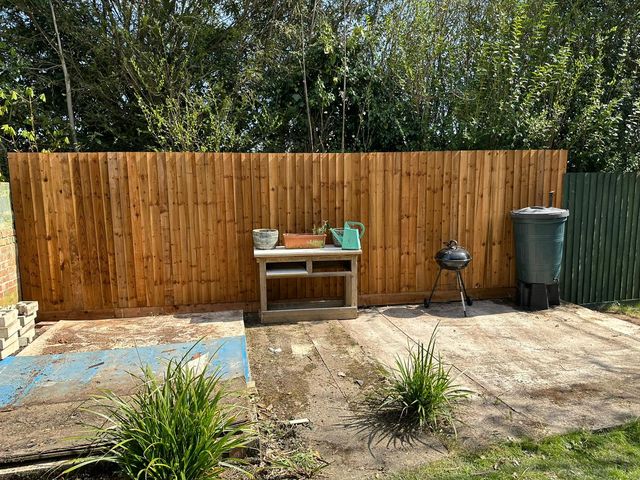 A run of new closeboard fencing across the end of a patio